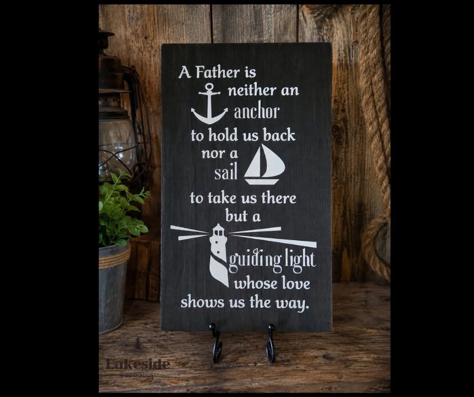 A Father is a guiding light sign with anchor and sail