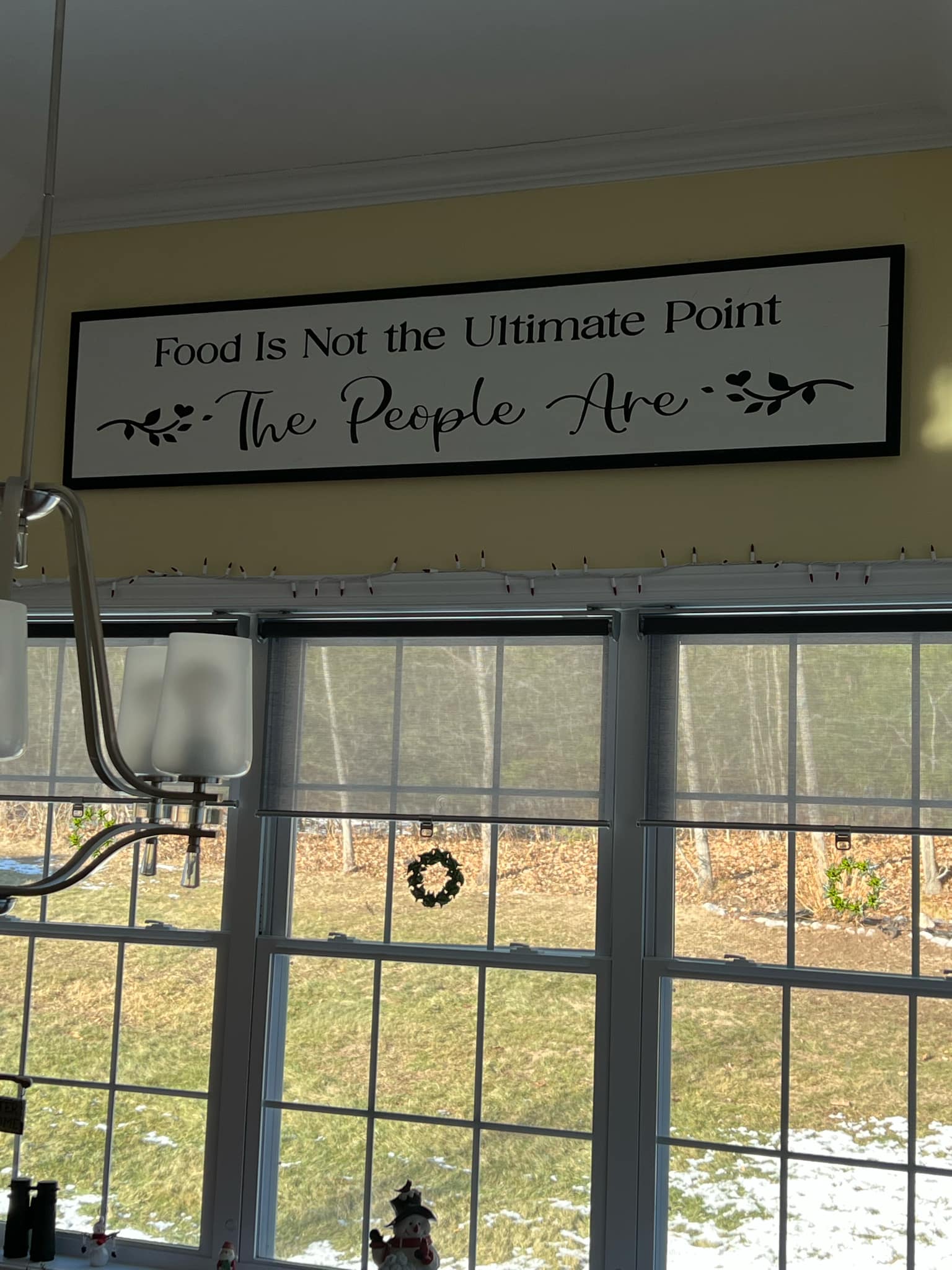 Food is Not the Ultimate Point The People Are long sign hung above windows