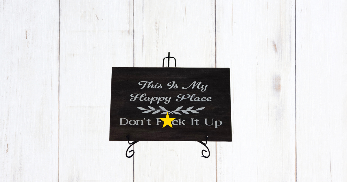 This Is My Happy Place Don't Fuck It Up sign on dark stained pine