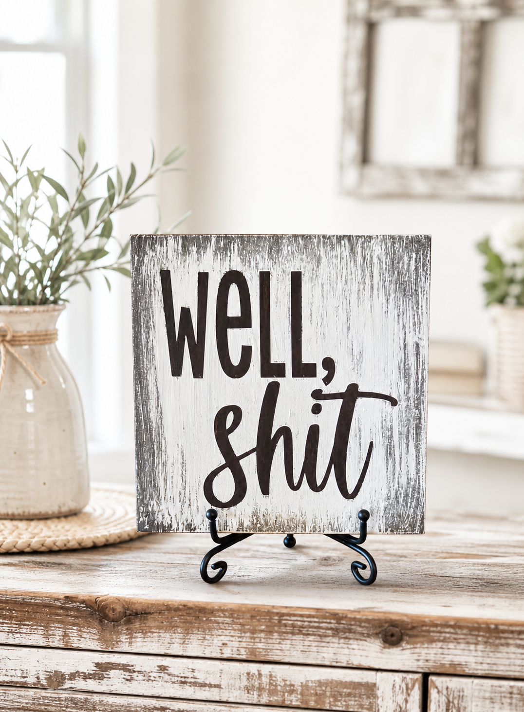 Well Shit sign on distressed white rustic wood