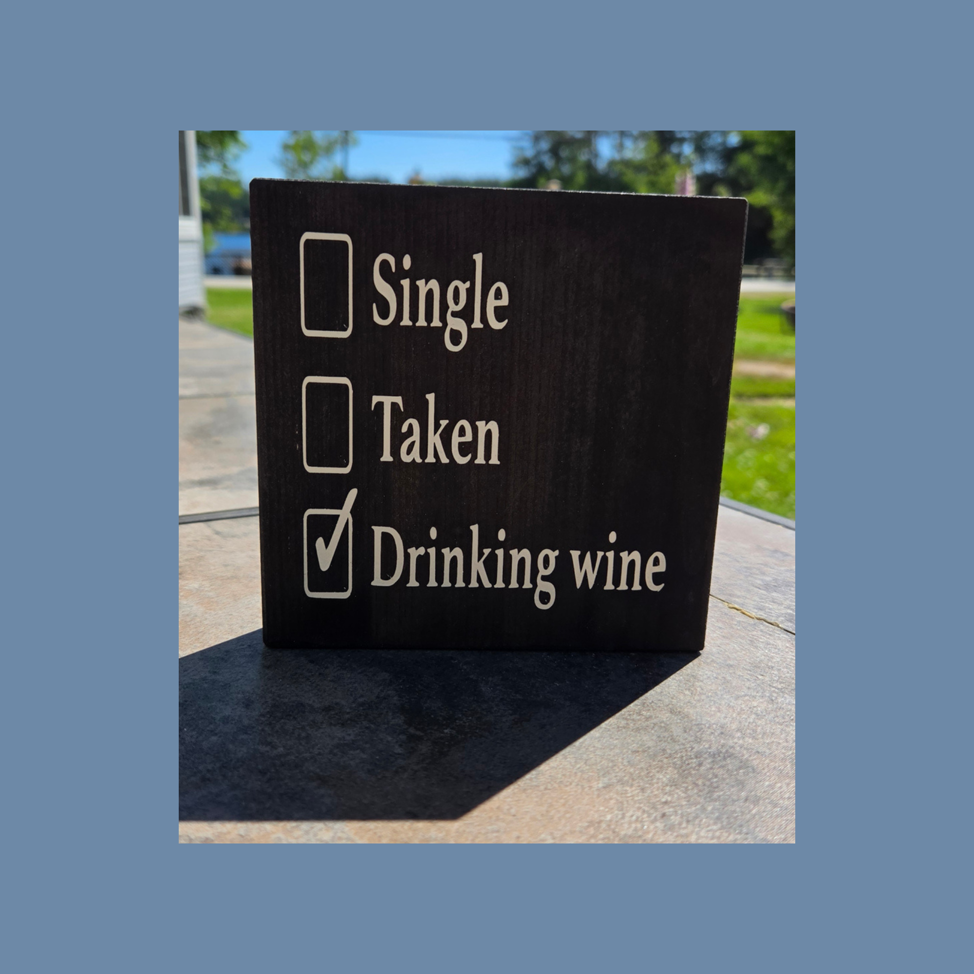 Single Taken Drinking Wine sign on dark pine