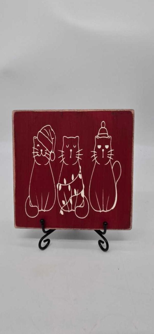 Three Christmas Cats sign on red pine