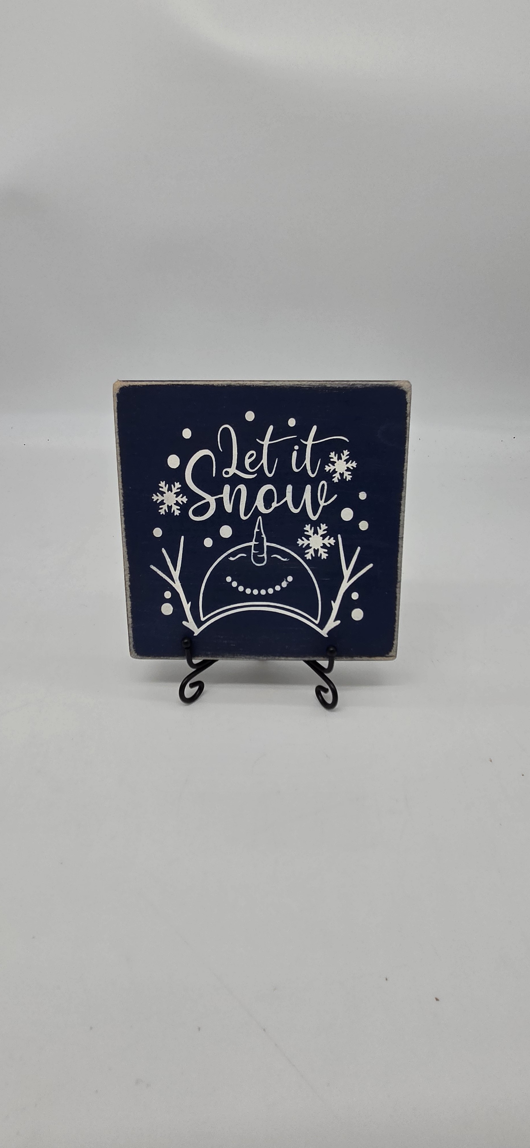 Let it Snow snowman sign on navy pine